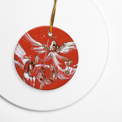 Christmas Angels ceramic ornament on a gold string over a white plate