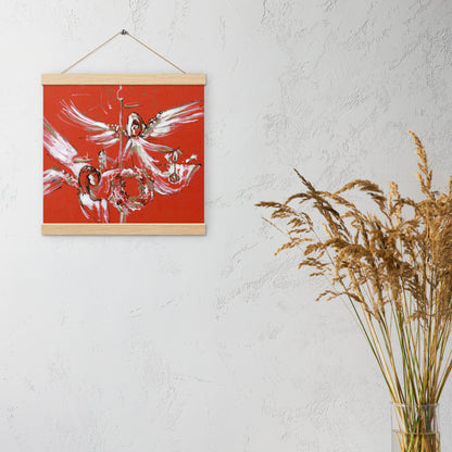 Christmas Angels hanging poster on a light wall beside dried grasses