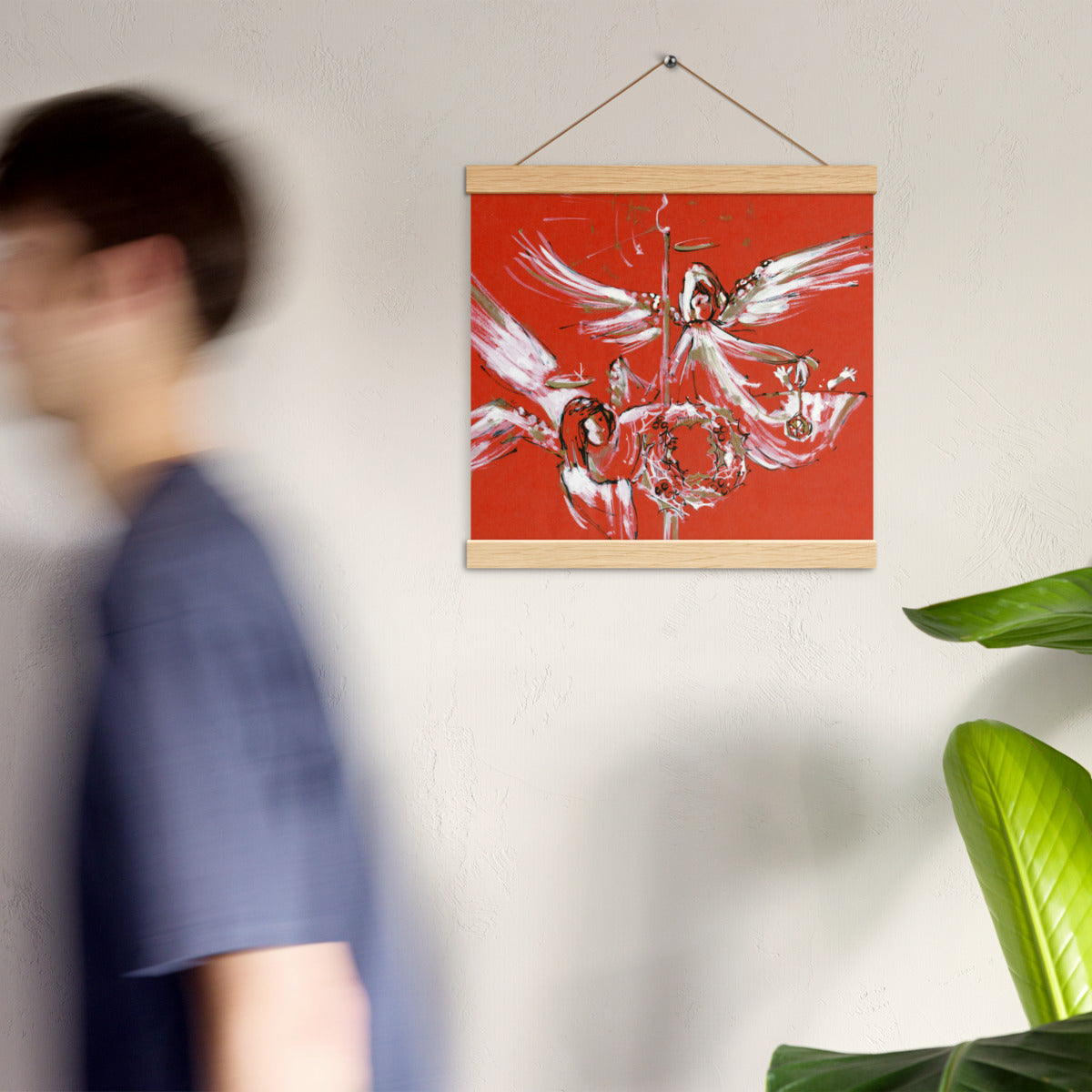 Christmas Angels hanging poster on a wall in a bright room