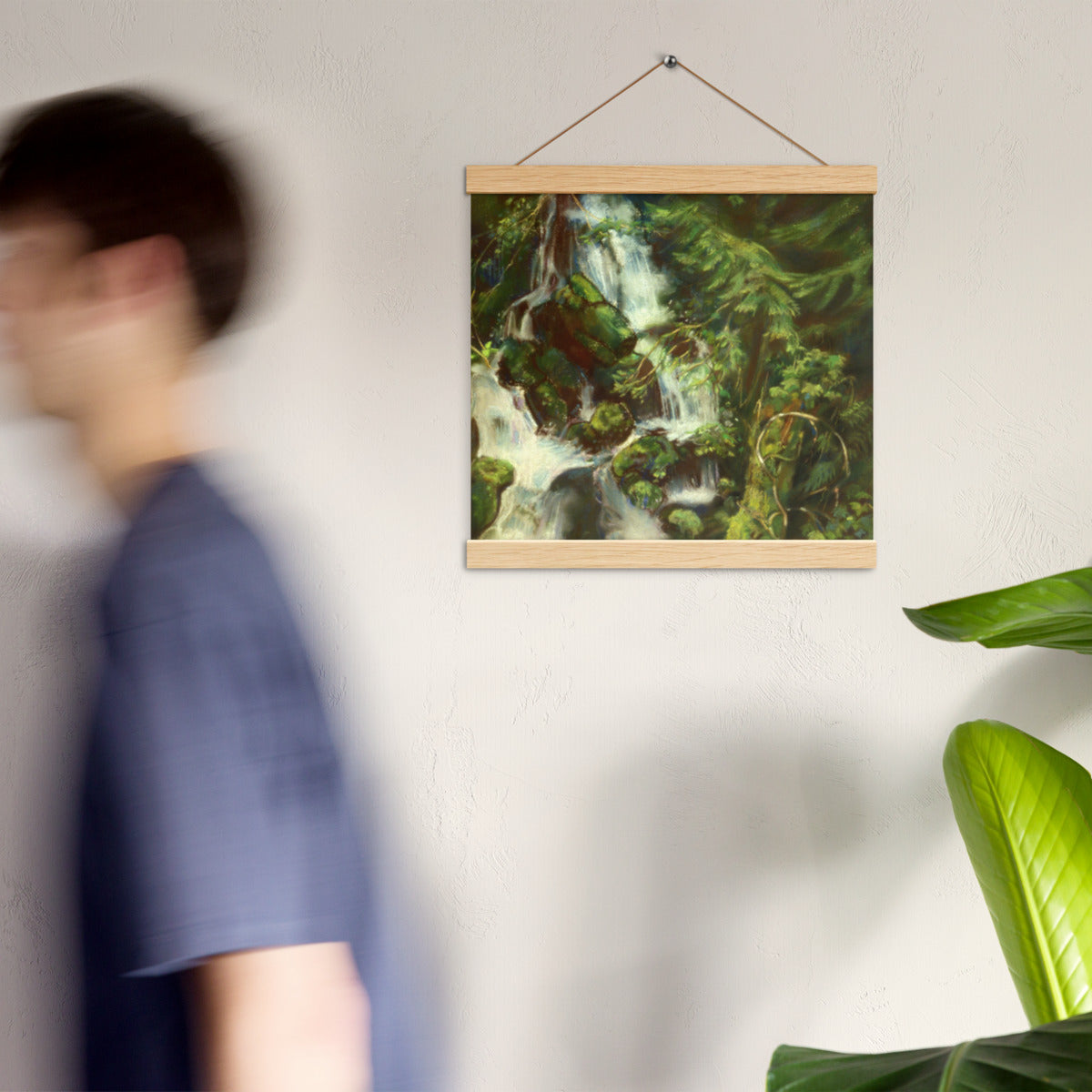 Woodland Waterfall hanging poster on a wall in a bright room