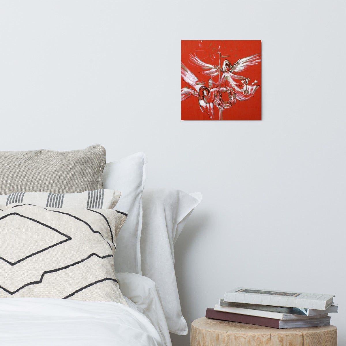 Christmas Angels metal print hanging above a bed with white pillows