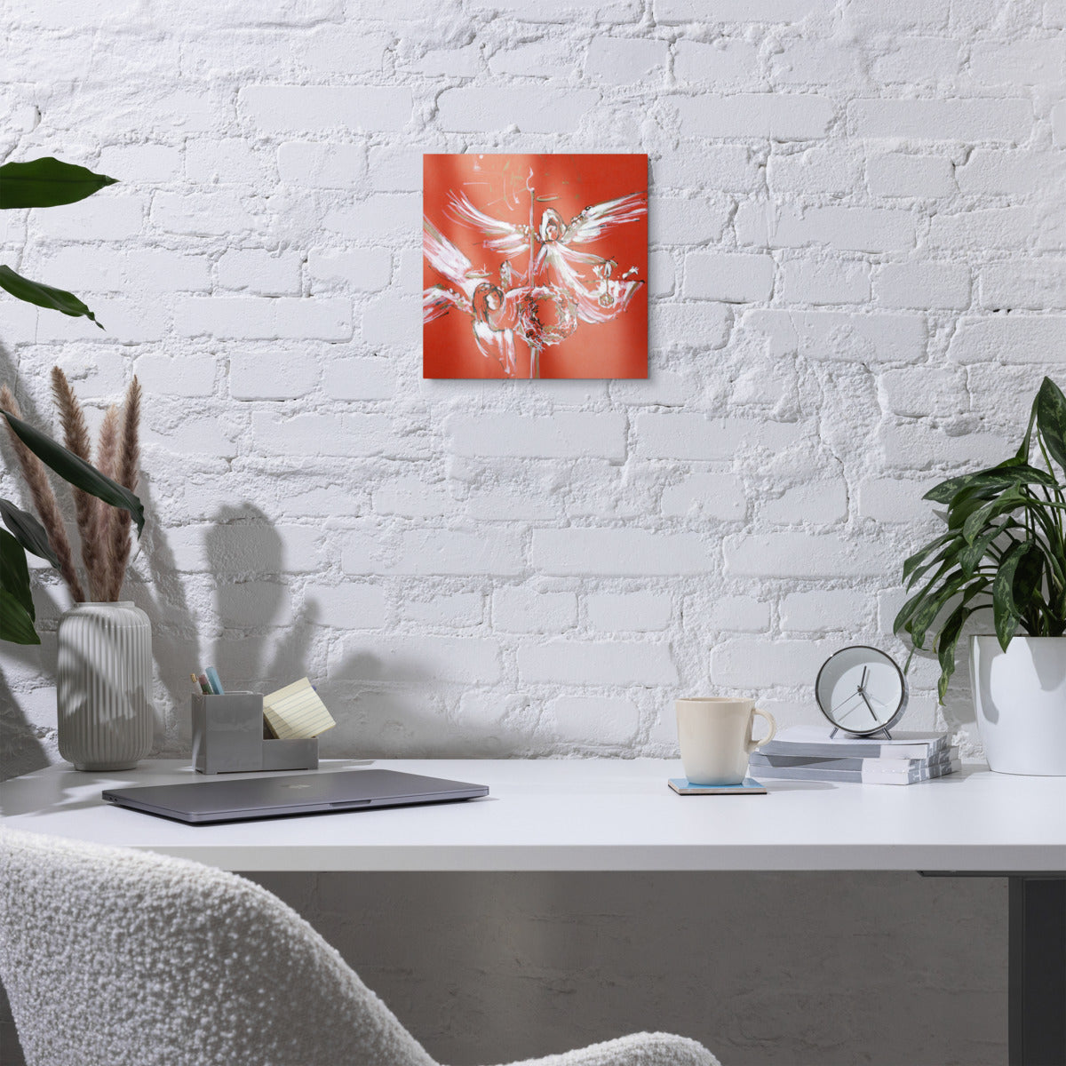 Christmas Angels metal print on a white brick wall above a desk
