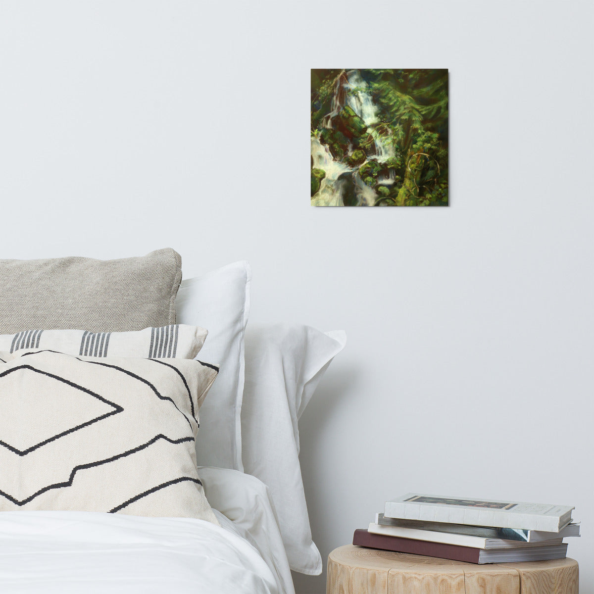 Woodland Waterfall metal print hanging above a bed with white pillows