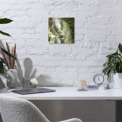 Woodland Waterfall metal print on a white brick wall above a desk